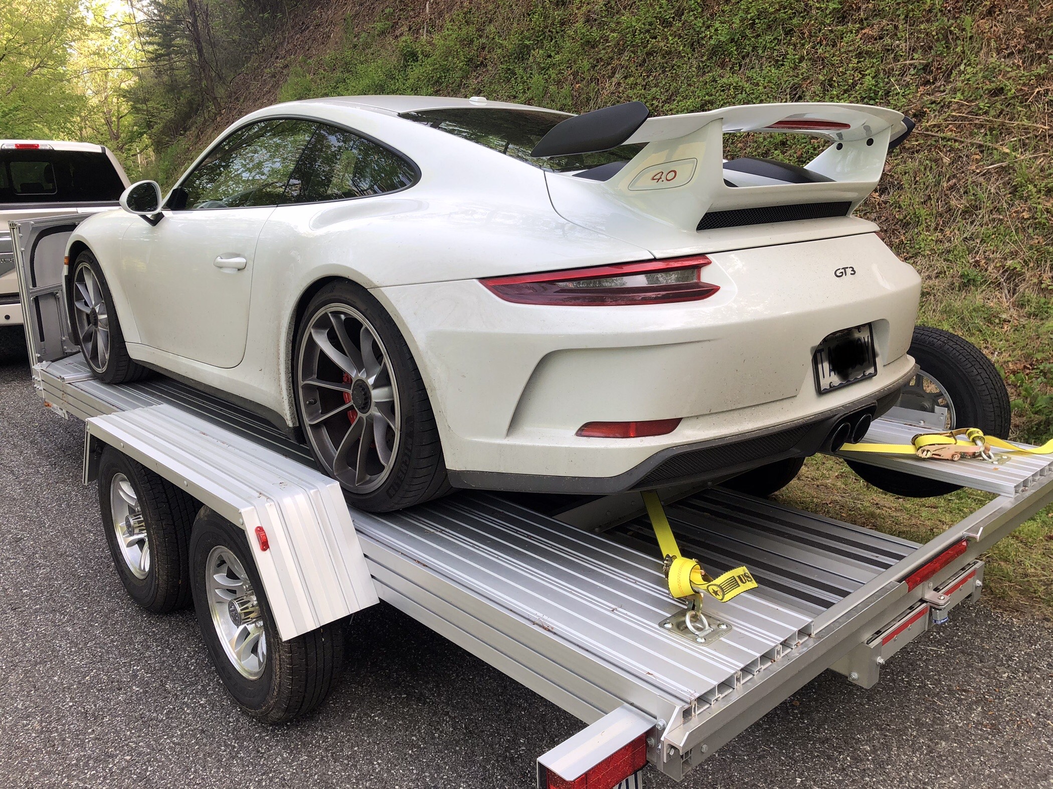 Customer trailer with race car loaded, driveway setting