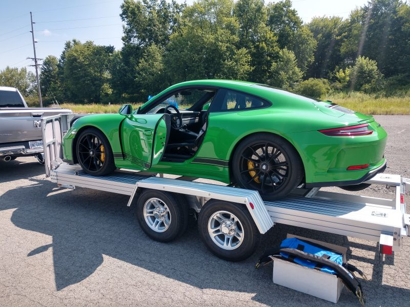 Green Porsche 911 GT3 on open trailer